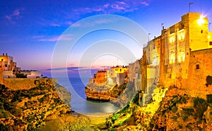 Polignano a Mare, Puglia, Italy: Sunrise at Cala Paura gulf with Bastione di Santo Stefano and Lama Monachile beach