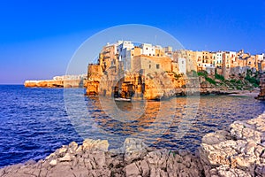 Polignano a Mare, Puglia, Italy: Sunset at Cala Paura gulf with Bastione di Santo Stefano and Lama Monachile beach