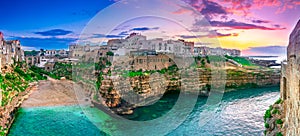 Polignano a Mare, Puglia, Italy: Sunset at Cala Paura gulf with Bastione di Santo Stefano and Lama Monachile beach