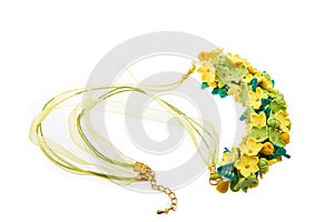 Polimer clay necklace with floral ornament isolated on white background. Female accessories, decorative ornaments and jewelry.