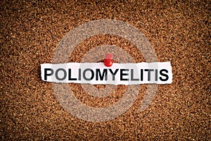 Poliomyelitis written on a torn piece of paper that is on a bulletin board