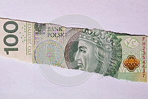 Polish 100 ZÅ‚otych banknote in torn paper hole