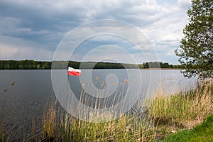 Polish flag on the background of the lake