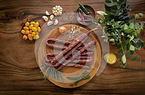 Polish kabanos sausages on rustic wood table with natural ingredients photo