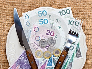 Polish money on kitchen table, coast of living