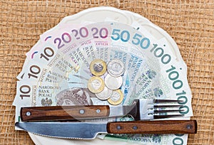 Polish money on kitchen table, coast of living