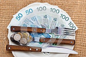 Polish money on kitchen table, coast of living