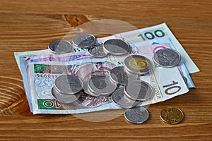 Polish money laying on a table. PLN banknotes and coins