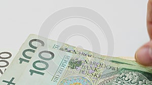 Polish money Zloty. Recalculation of money. Isolated. The hand counts money paper bills one hundred two hundred zloty. Polish bank