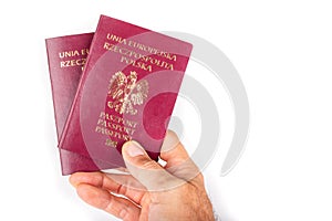 Polish passport held in a man& x27;s hand. Identification document needed in a foreign country