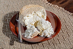 Polish skimmed fresh smoked milk twarog cheese, white cow cheese compared to curd, quark, or cottage cheese made in Poland