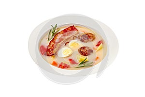 Polish soup zur with bacon, sausages and egg isolated on white