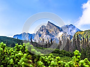 Polish Tatra mountains summer landscape with blue sky and white clouds.