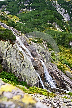 Polish Tatra Mountains, Wielka Siklawa waterfall, clear mountain water flowing down the mountain slope, view from the hiking trail