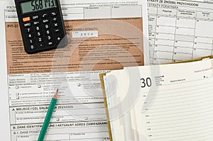 Polish tax form with pencil, calendar and calculator