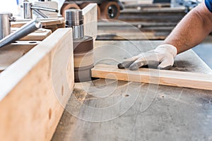 Polish up a board in a carpentry workshop.