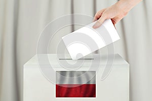 Polish Vote concept. Voter hand holding ballot paper for election vote on polling station