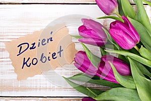 Polish Women`s Day card and a bouquet of beautiful tulips on wooden background