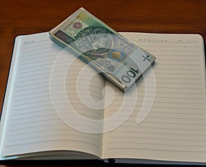 polish zloty currency bills on a notebook