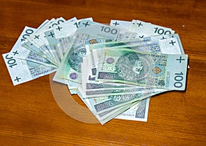 polish zloty currency hundreds bills on wooden table