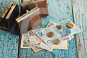 Polish zloty with wallets, wooden background