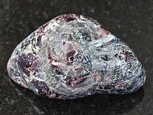 polished Almandine garnet crystals on dark
