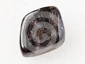 polished anthophyllite gemstone on white