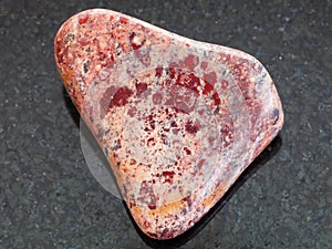 polished Brecciated Jasper stone on dark