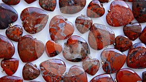 Polished brecciated jasper stone hearts are rotating