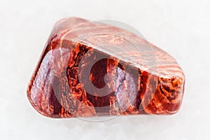 polished Brecciated red jasper gemstone on white