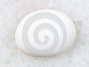 polished cacholong (white opal) gemstone on white