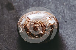 Polished carnelian gemstone on a black background