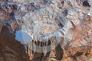 Polished glowing surface of meteorite, composed by high density heavy metals, mostly iron and nickel with traces of cobalt. Close