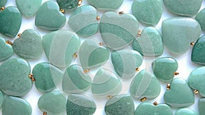 Polished green aventurine stone hearts are rotating