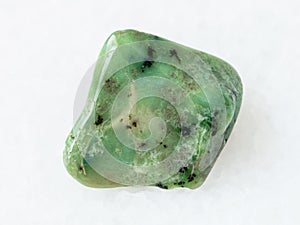 polished green Grossular garnet gemstone on white