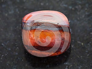 polished jaspilite gem stone on dark background