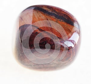 polished jaspilite gemstone on white