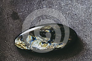 Polished labradorite gemstone on a black background