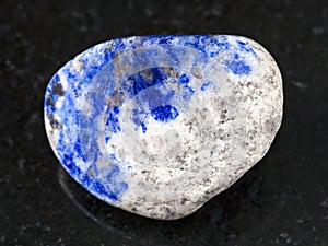 polished lazurite stone on dark background