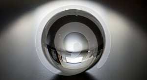 A polished metal sphere rests on