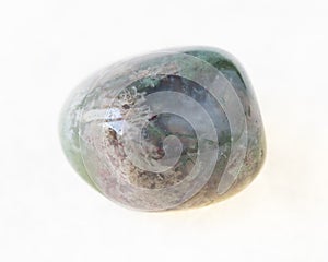 polished Moss Agate gemstone on white