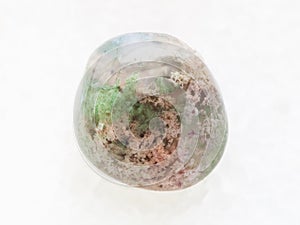 polished Moss Agate gemstone on white marble