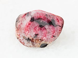 polished pink rhodonite gem stone on white