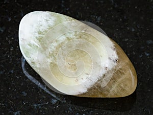 Polished Prasiolite gemstone on black photo