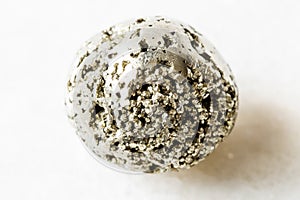 Polished Pyrite fool`s gold rock on white