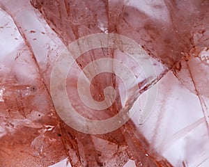 Polished quartz stone with red hematite inclusions photo