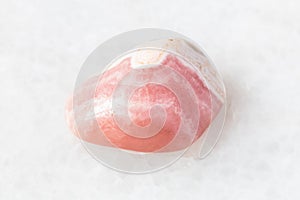 Polished Rhodochrosite rock on white marble