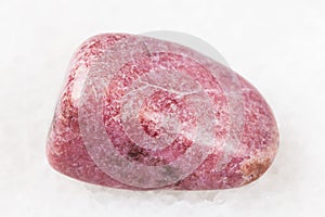 polished rhodonite gem on white