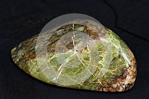 A polished sample of unakite granite with epidote