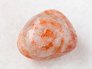 polished sunstone (heliolite) gem stone on white